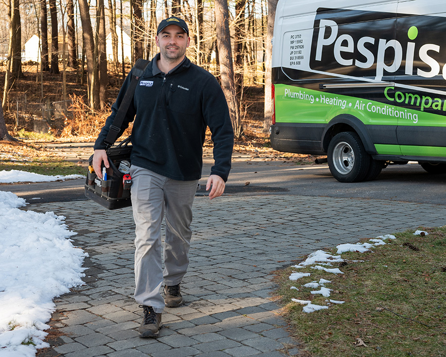 Pespisa plumbing technician walking with tools