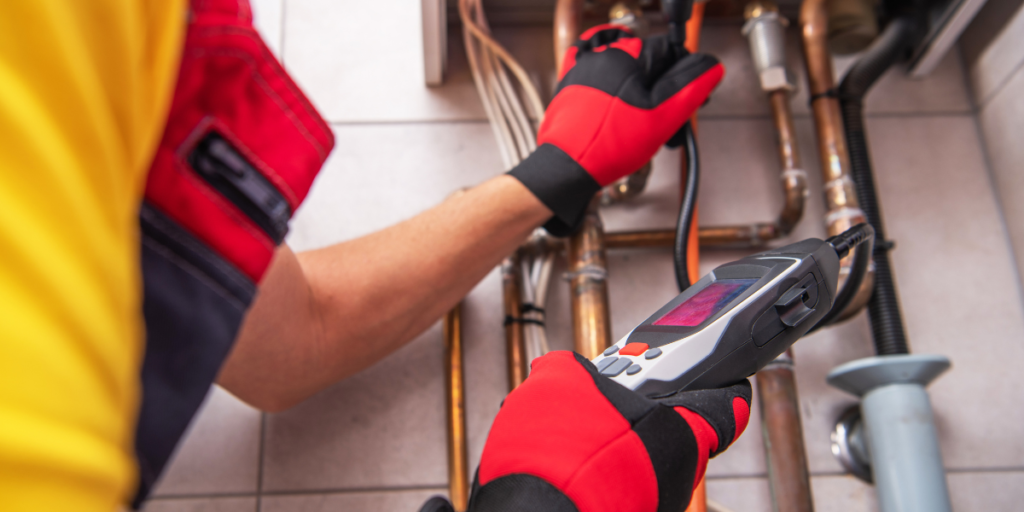 Plumber inspecting pipes during a repair.