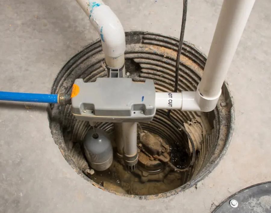Open sump pump pit in a basement floor
