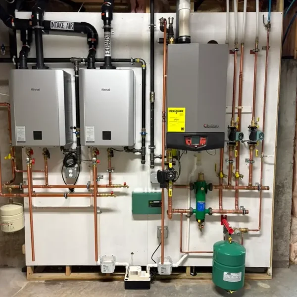 Completed wall-mounted tankless heating system with copper piping and expansion tank